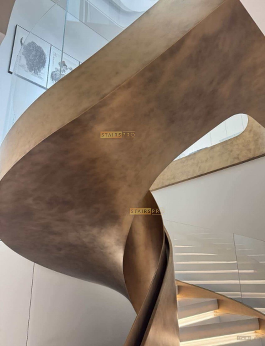 Bronze-finished curved feature staircase Bronze-finished curved feature staircase