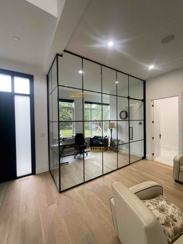 Interior glass partition wall dividing a living space Interior glass partition wall dividing a living space