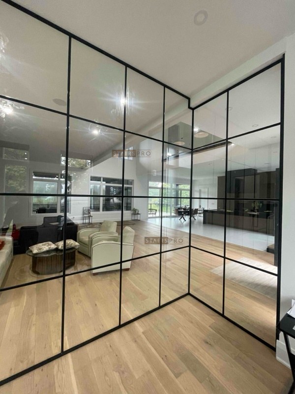 Corner detail of a framed interior glass partition wall