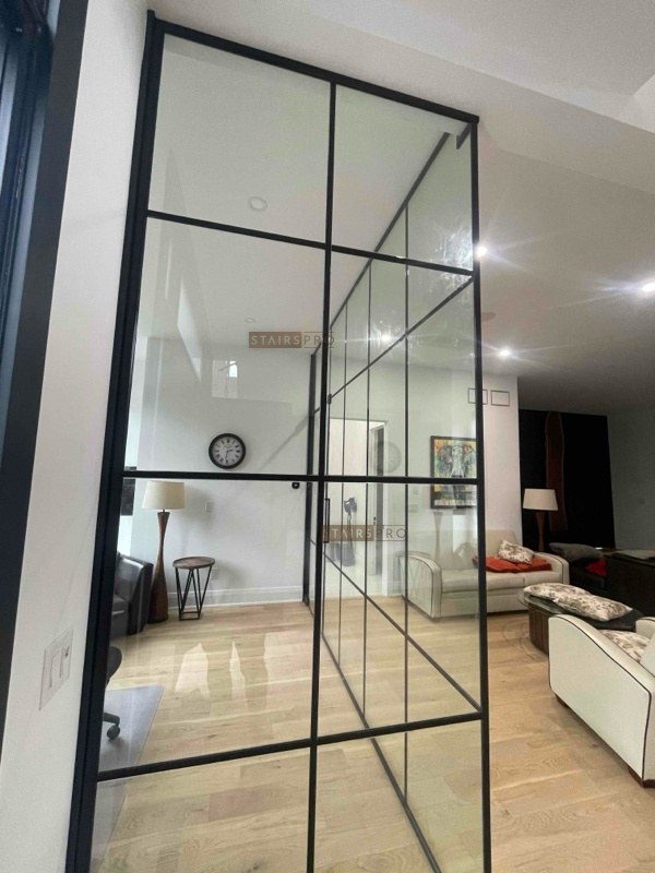 Interior glass partition dividing a study from the living space