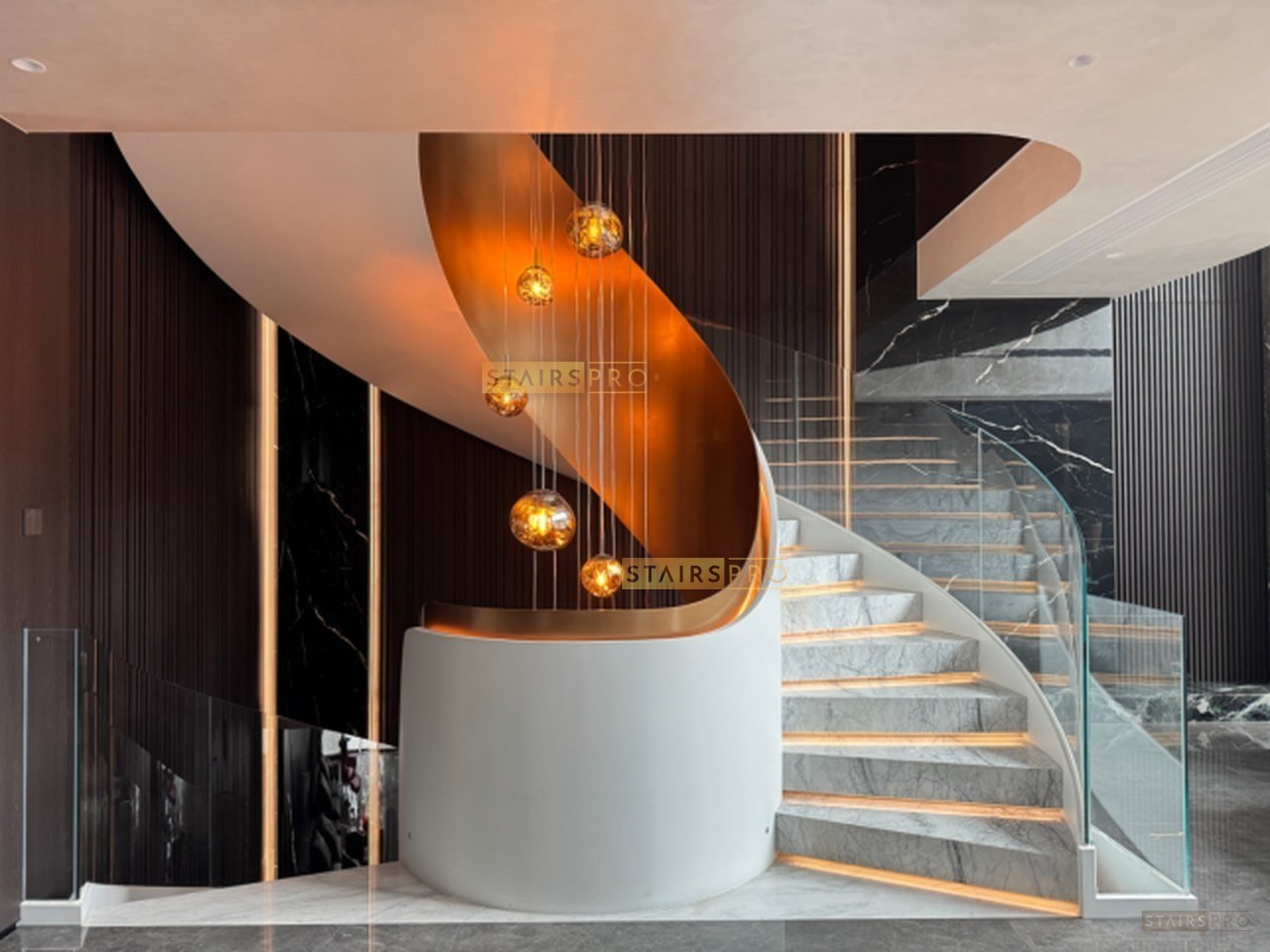 Luxury curved staircase with stone treads and a glass balustrade Luxury curved staircase with stone treads and a glass balustrade