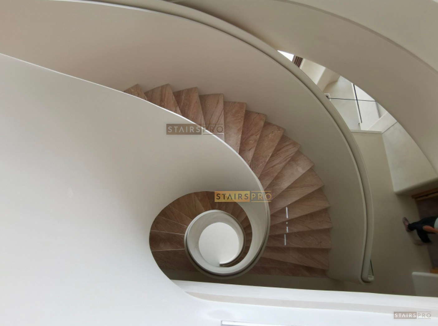 Luxury curved staircase with stone treads and a glass balustrade Luxury curved staircase with stone treads and a glass balustrade
