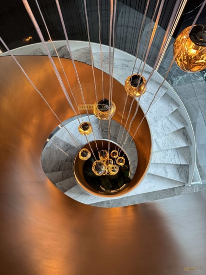 Sculptural curved staircase with a frameless glass balustrade Sculptural curved staircase with a frameless glass balustrade