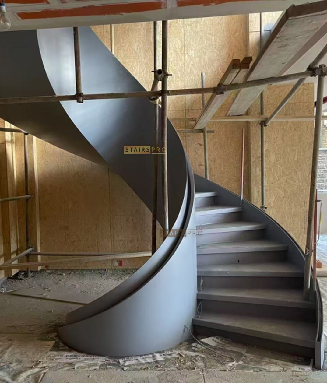 Sculptural curved staircase with a frameless glass balustrade