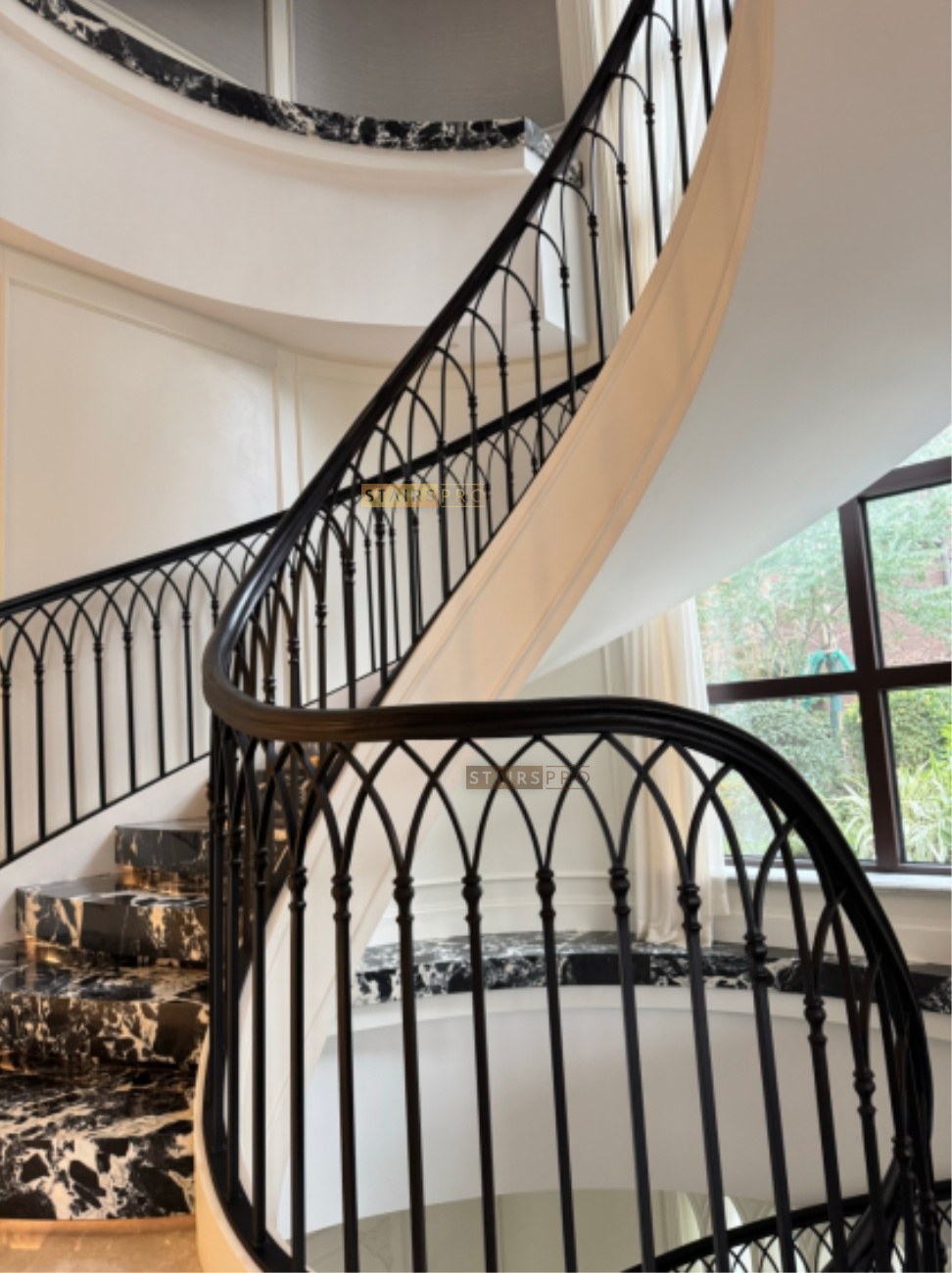 Hand-forged wrought iron balustrade in a grand entrance hall Hand-forged wrought iron balustrade in a grand entrance hall